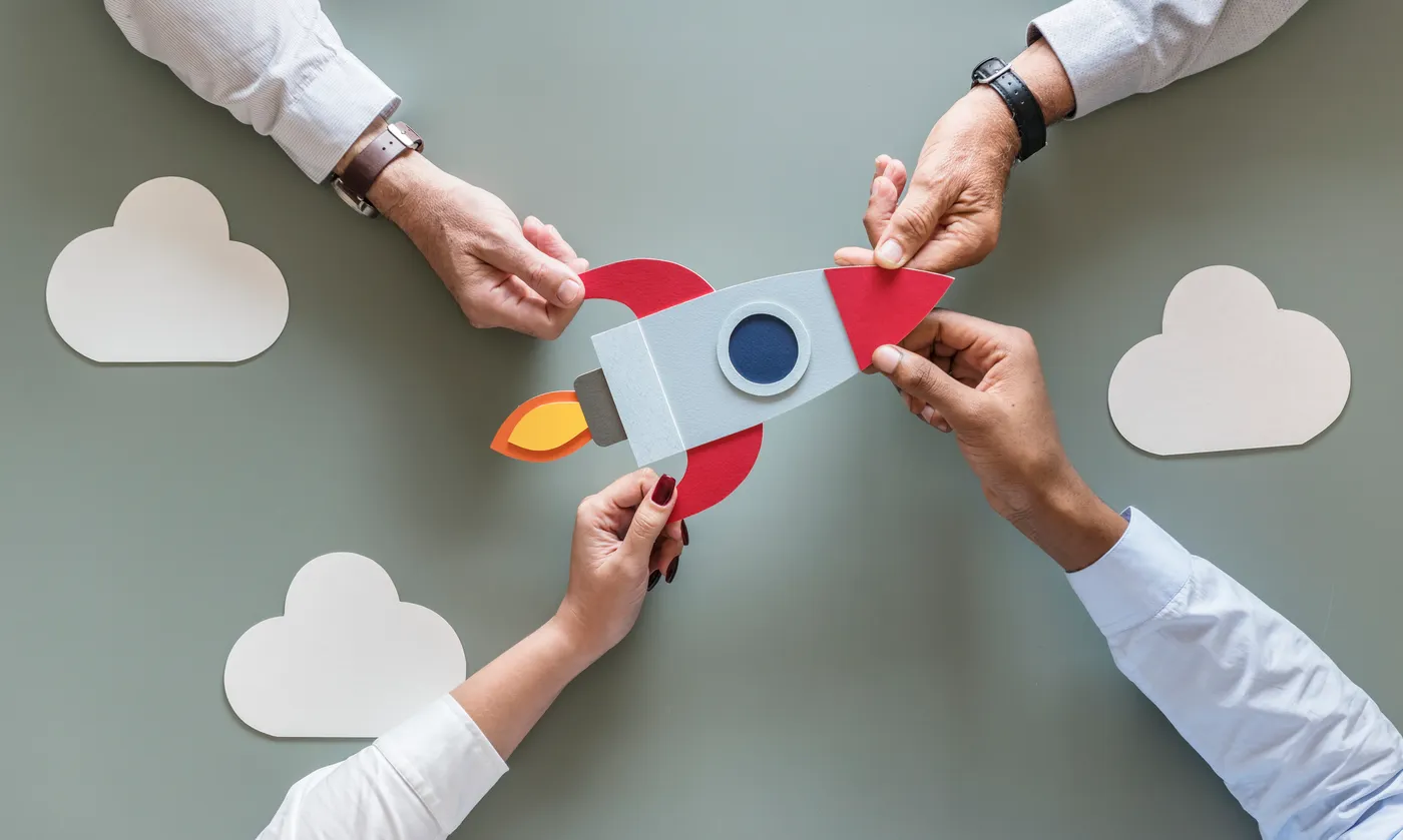 Rocket with businesses holding onto it